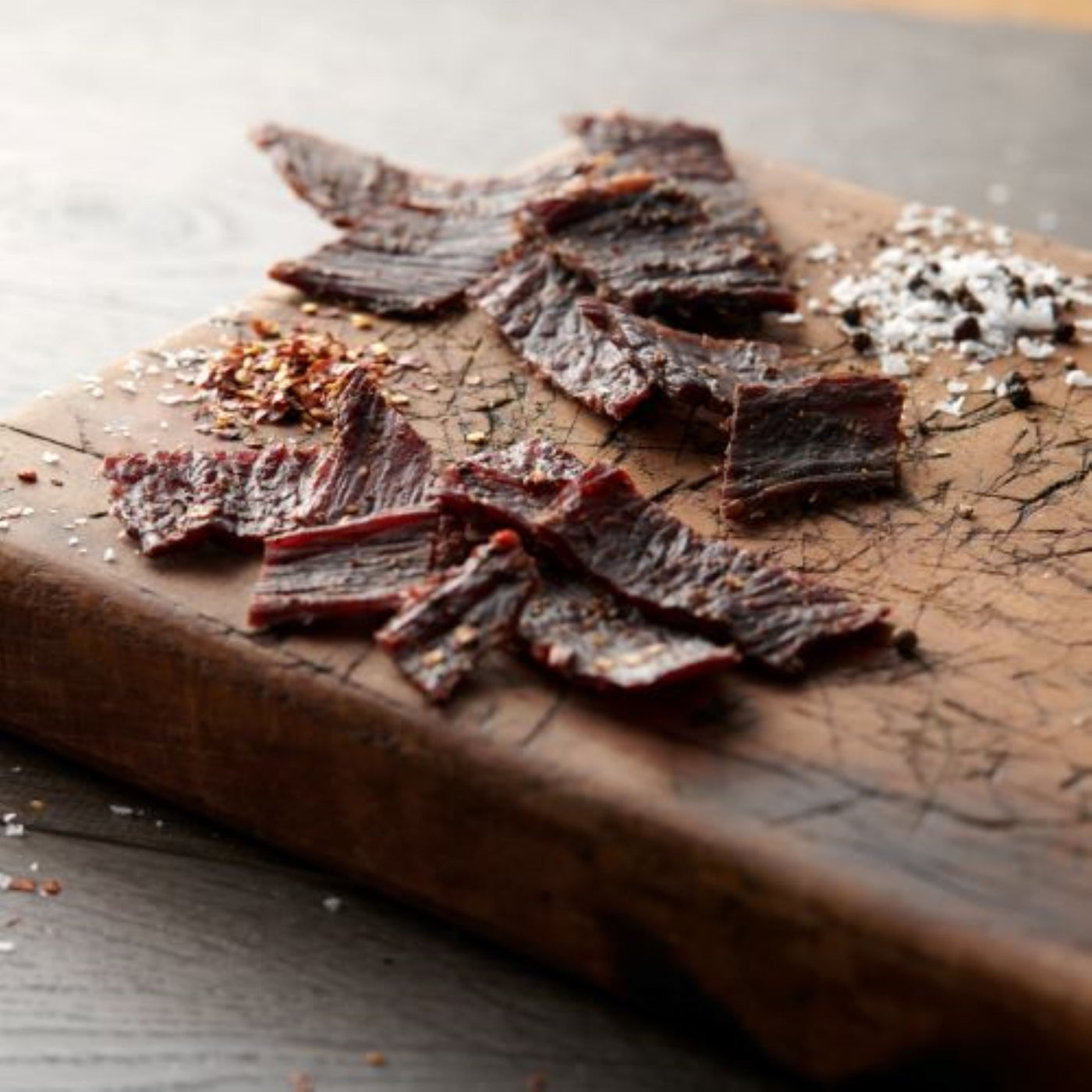 44 farms beef jerky on cutting board with seasoning 